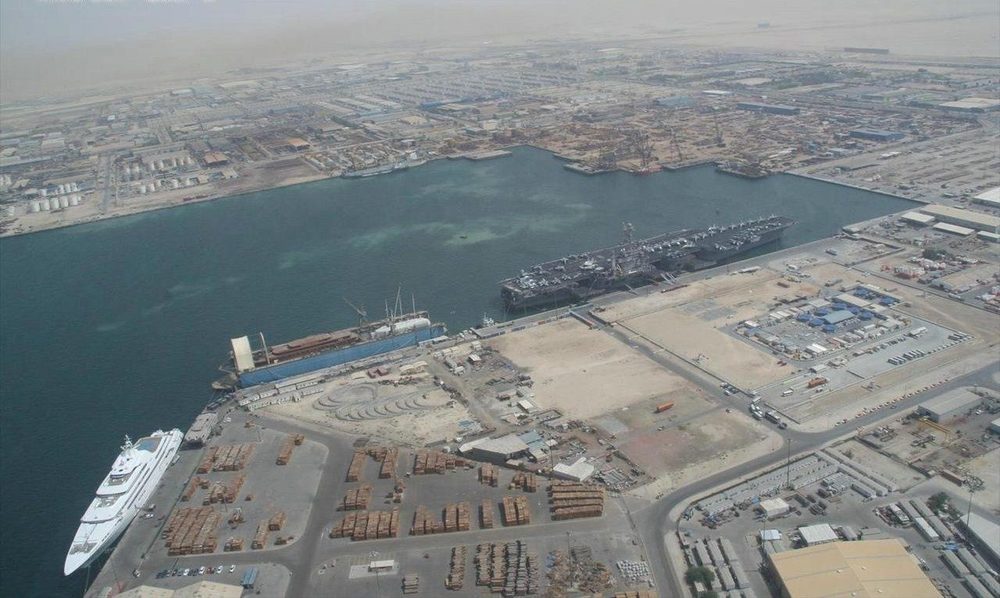 Quays, cranes and stacked cargo at the Port of Jebel Ali, seen from the air.