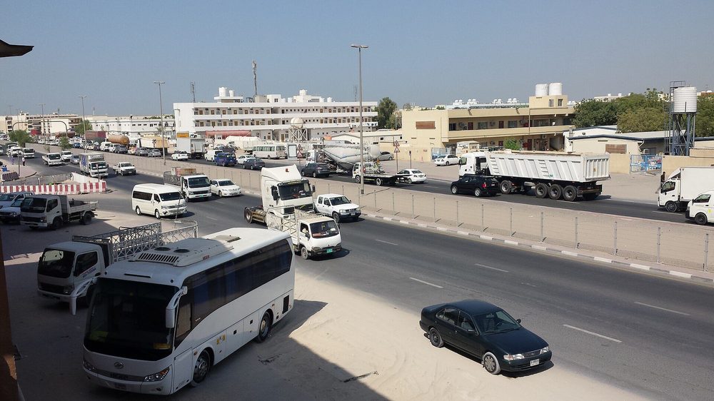 Trucks, buses and warehouses along a road in the Al Quoz industrial area of Dubai.